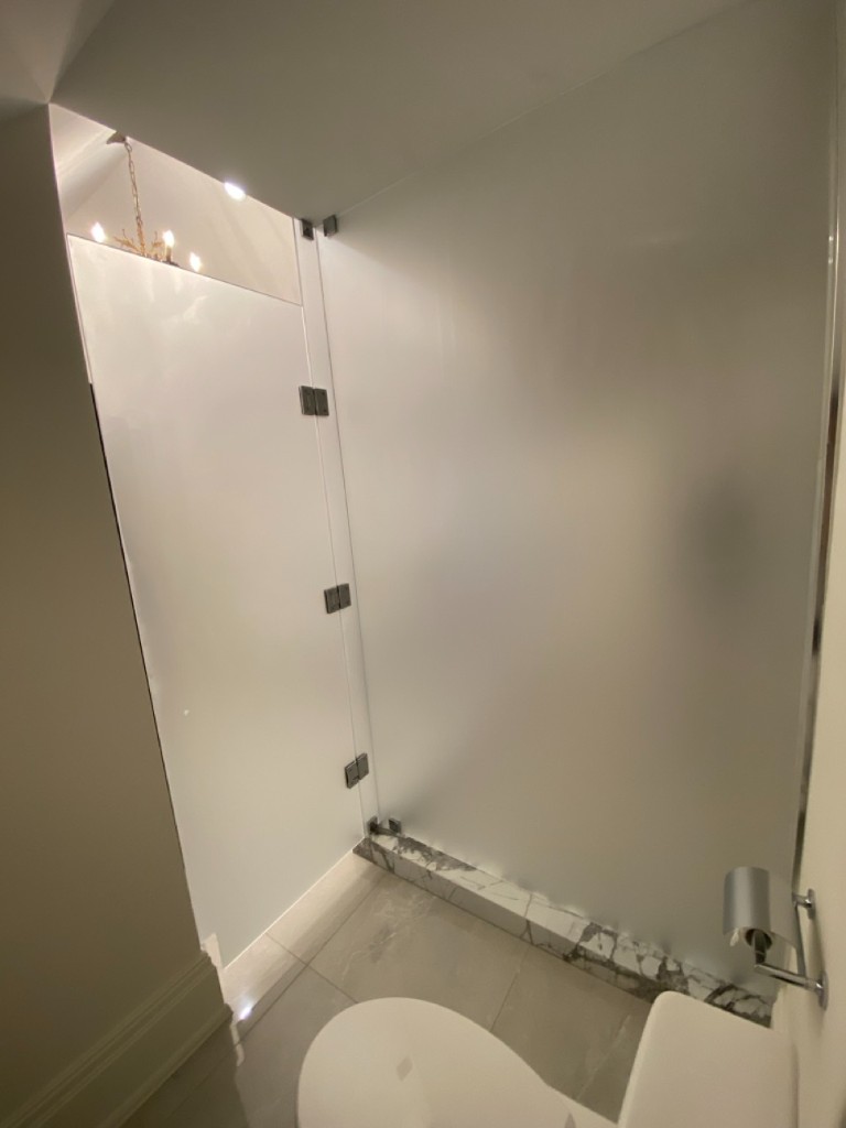 Frosted glass partition wall with chrome hardware