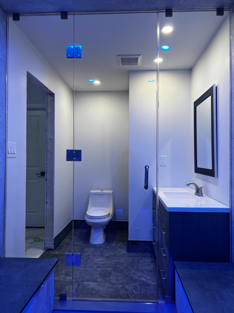 Floor-to-ceiling glass-enclosed room with frameless doors